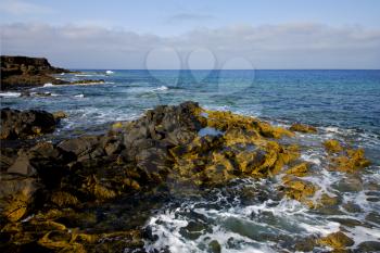 water  in lanzarote  isle foam rock spain landscape  stone sky cloud beach  
