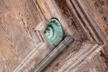 defocused abstract   rusty brass brown knocker in a  door curch  closed wood lombardy italy  varese lonate pozzolo

