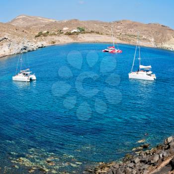 in europe greece santorini island hill and rocks on the summertime beach 