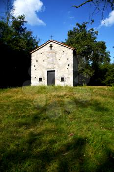  italy  lombardy     in  the arsago seprio   old   church   closed brick tower      wall grass