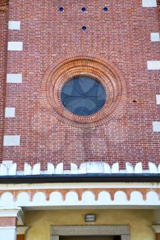 italy  lombardy     in  the  sumirago  old   church   closed brick tower   wall rose   window tile   