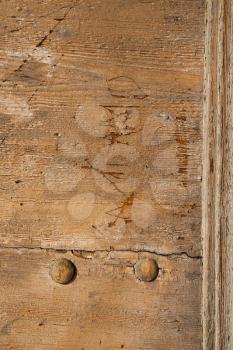 abstract   rusty brass brown knocker in a  door curch  closed wood lombardy italy  varese lonate pozzolo
