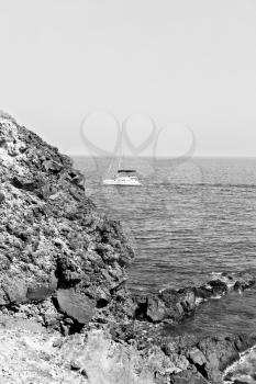 in europe greece santorini island hill and rocks on the summertime beach 