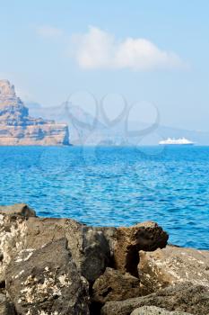 in europe greece santorini island hill and rocks on the summertime beach 