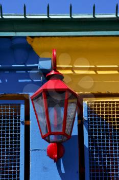 red street lamp  and a colorated  wall in la boca buenos aires argentina

