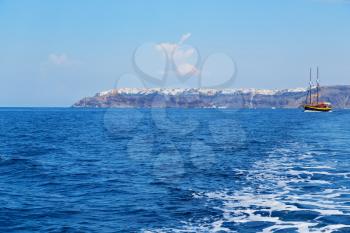 sailing in europe greece santorini island hill  and rocks on the summertime beach 