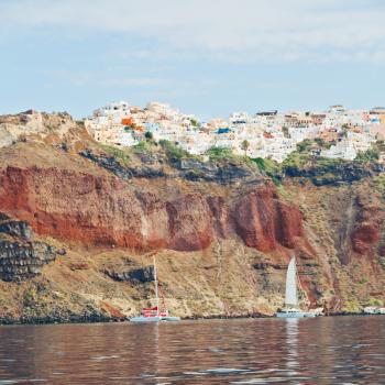 in europe greece santorini island hill and rocks on the summertime beach 