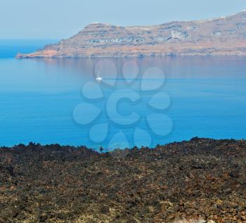 in europe greece santorini island hill and rocks on the summertime beach 