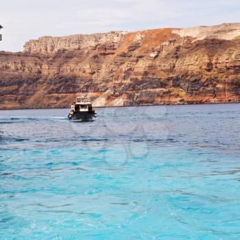 sailing in europe greece santorini island hill  and rocks on the summertime beach 