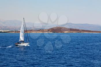 sailing in europe greece santorini island hill  and rocks on the summertime beach 