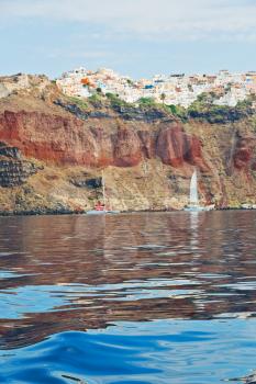 in europe greece santorini island hill and rocks on the summertime beach 