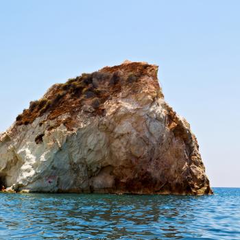 in europe greece santorini island hill and rocks on the summertime beach 