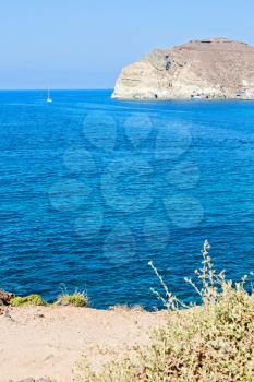 in europe greece santorini island hill and rocks on the summertime beach 