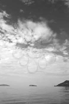 in europe greece santorini island hill and rocks on the summertime beach 