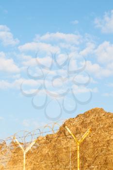 and cloudy sky in oman barbwire in the background 