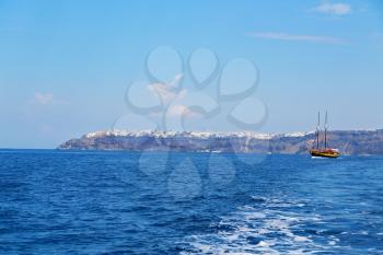 sailing in europe greece santorini island hill  and rocks on the summertime beach 