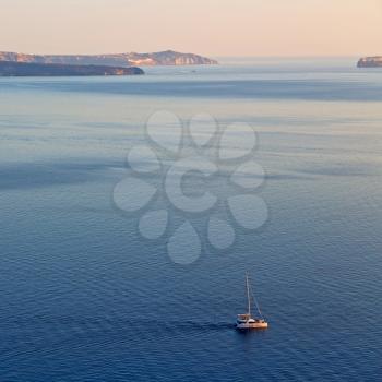 in europe greece santorini island hill and rocks on the summertime beach 