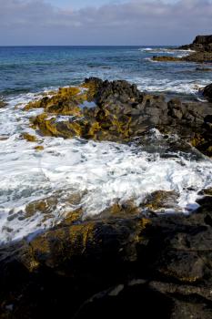 beach  light  water  in lanzarote  isle foam rock spain landscape  stone sky cloud   
