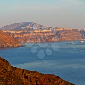 in europe greece santorini island hill and rocks on the summertime beach 