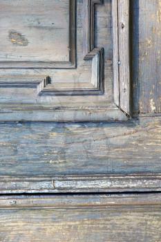 in  italy  patch lombardy    cross milan blur   abstract   rusty brass brown knocker  a  door curch  closed wood
