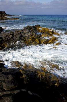 beach  light  water  in lanzarote  isle foam rock spain landscape  stone sky cloud   

