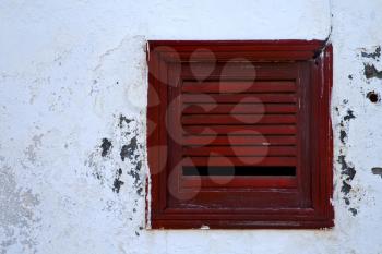 spain brown wood   window in a white wall arrecife lanzarote 

