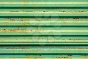 Old rusty metal ribbed surface painted in green color