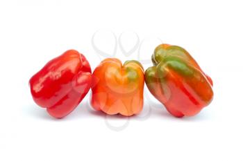 Three sweet pepper fruits on a white background