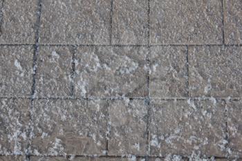 The snow-covered sidewalk tile 30417