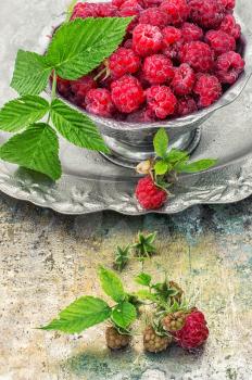 Plucked raspberries in vintage iron ramekin.Photo tinted.Selective focus