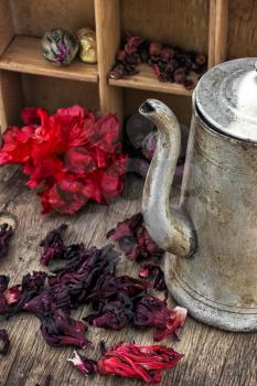 Hibiscus tea rose and welding on the background of the tea shelves in vintage style.Photo tinted.Selective focus