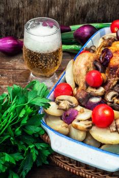 chicken baked with mushrooms,potatoes and vegetables in glass form