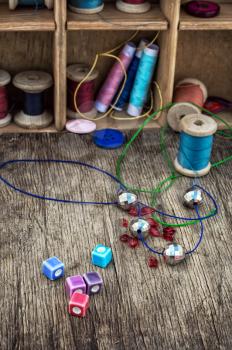different tools for needlework beading and sewing in vintage style.Selective focus