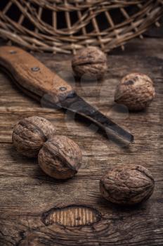 few walnuts on wooden background from autumn harvest.