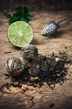 tea brew with lime and mint on wooden background in rustic  style