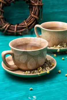 fragrant tea brewed with chamomile in ceramic mugs