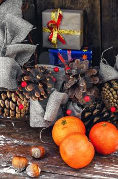 Winter composition with tangerines,pine cones and gifts