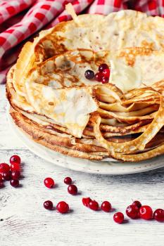 Freshly baked pancakes on a light background for the holiday carnival