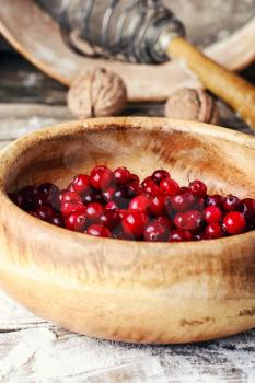 And ripe cranberries in a wooden bowl on the kitchen table