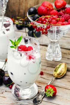 Dairy ice cream with strawberries,currants and raspberries in the glass