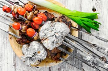 Beef cooked with vegetables on skewers.Top view