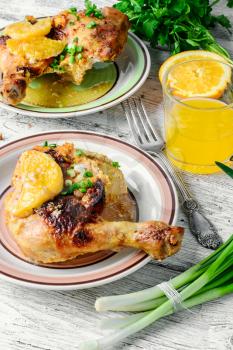 Dinner of baked chicken thighs in orange with spices