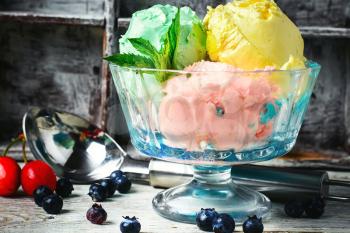 fruit ice cream scattered on background of blueberries