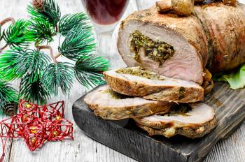 Dish of roulade of veal stuffed with mushrooms and spices and Christmas decorations
