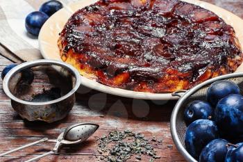 Homemade sweet cake with crop of plums in rustic style