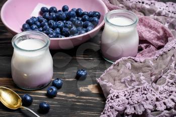 yogurt in glass jars of berries and fresh blueberry