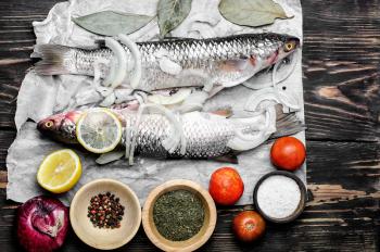 Two prepared for cooking fish with spices and seasonings