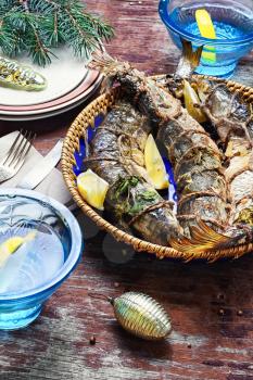 Fried fish stuffed with lemon and spices at the Christmas table