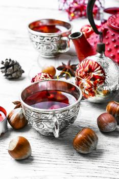 Cranberry tea in stylish cups at the Christmas background
