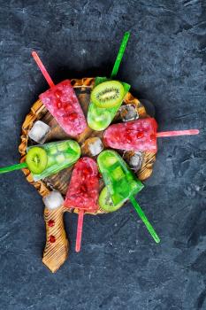 ice cream with kiwi and pomegranate on kitchen board